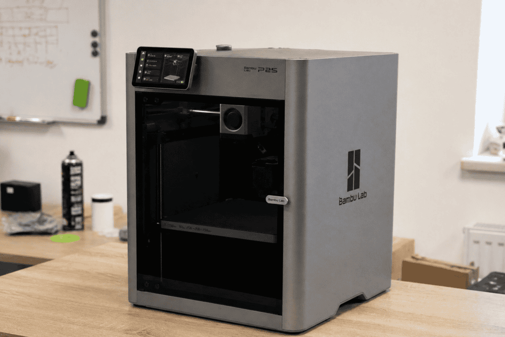 Bambu Lab P2S enclosed 3D printer with door closed, printing ABS material