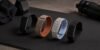 Garmin CIRQA, Fitbit Air, WHOOP 5.0, Polar Loop, and Amazfit Helio Strap arranged together as screen-free fitness trackers
