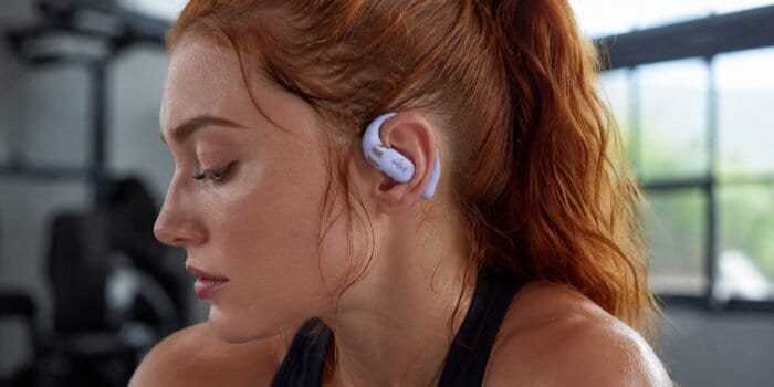 Shokz Review 2026 – woman wearing Shokz open-ear headphones during a workout